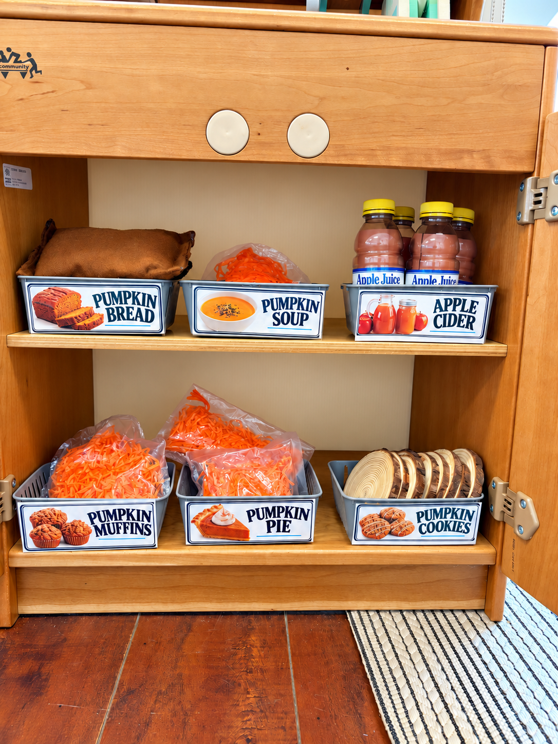 Repurposed containers and dramatic-play foods inside a preschool pumpkin patch café