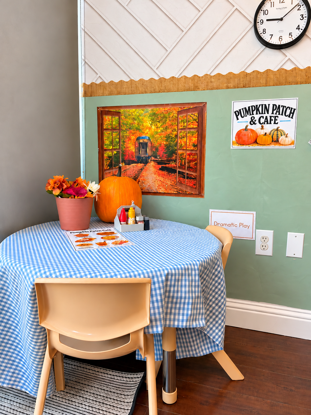 Pumpkin patch café table with menu, flowers, and a real pumpkin in a preschool classroom